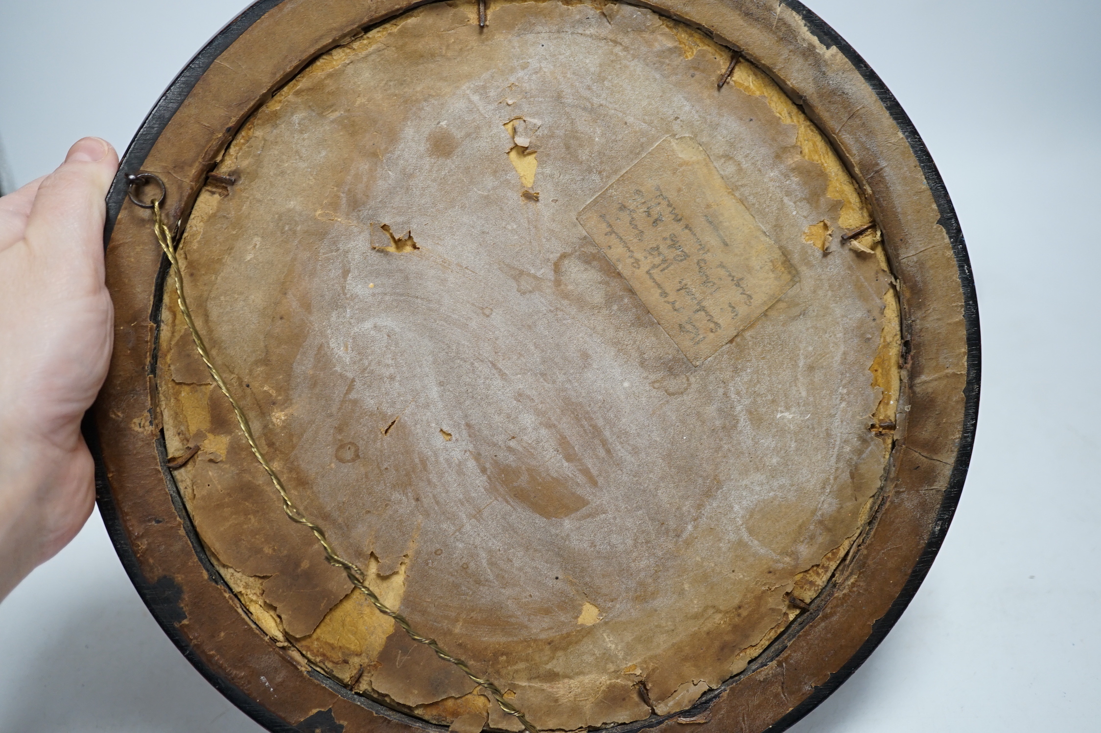An Arts and Crafts brass and copper roundel, in the manner of Archibald Knox, monogrammed CA, ebony framed, overall 27cm